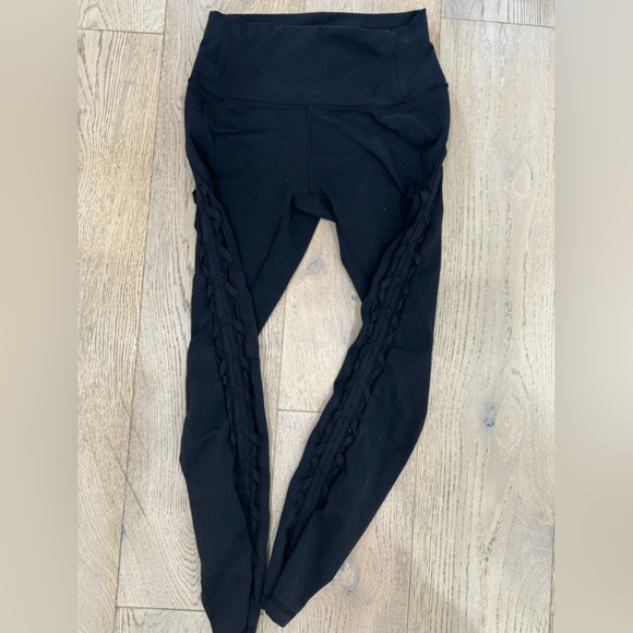 Lululemon black high-rise leggings. Side criss-cross mesh detail. Size 4 - Picture 1 of 3